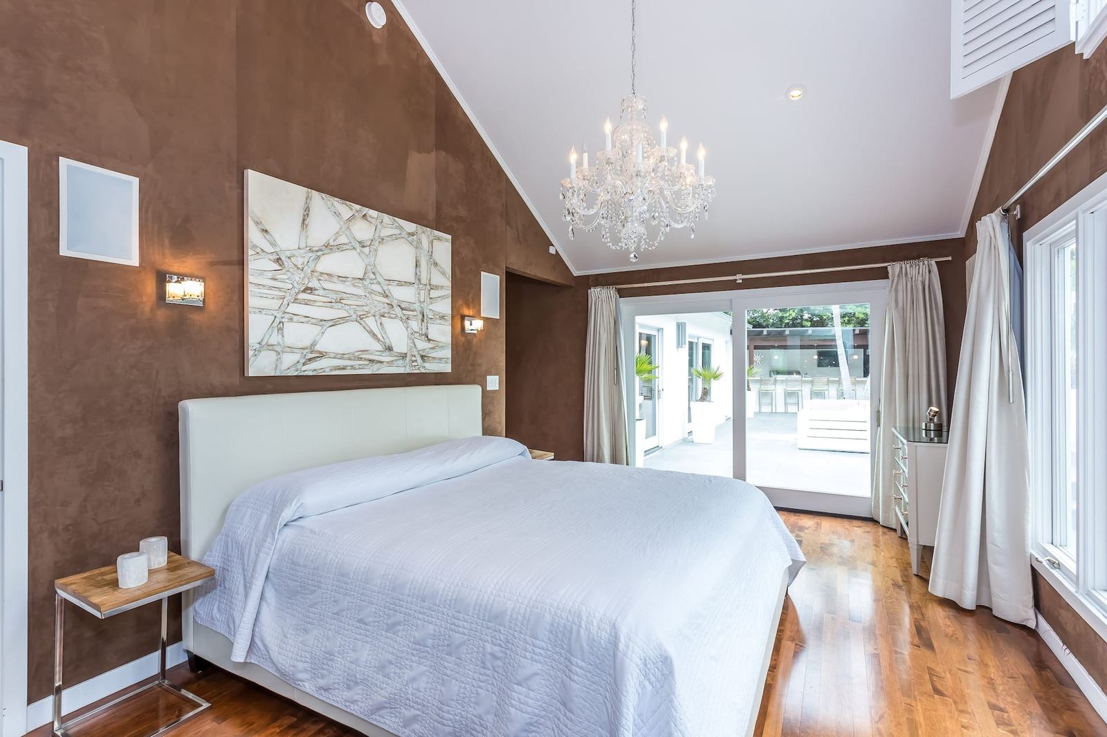 Guest bedroom with brown suede walls and modern art